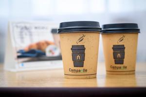 two coffee cups sitting on top of a table at Campanile Hotel & Restaurant Vlaardingen in Vlaardingen