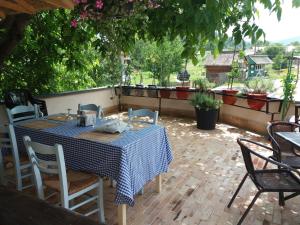 a table and chairs sitting on a patio at Pensiunea TOTAL din Ceahlău in Ceahlău