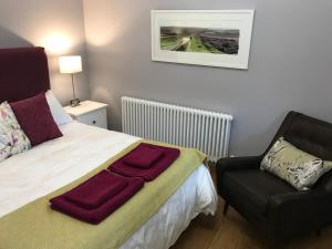 A bed or beds in a room at Curbar Hillside B&B