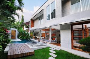 an external view of a house with a swimming pool at 4BR Villa Minggu - Minggu Villas Seminyak in Seminyak