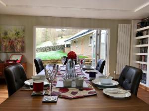 a dining room with a table with chairs and a dining room at Curbar Hillside B&B in Curbar