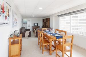 a dining room and living room with a table and chairs at Piropo in Gandía