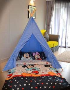 a childs bed with a blue canopy in a room at Meru Suites at Meru Valley Resort in Ipoh