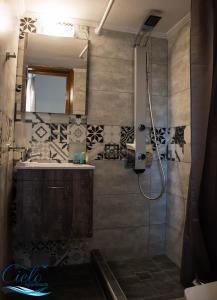 a bathroom with a shower and a sink and a mirror at Cielo Apartments in Poros