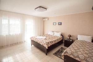 a bedroom with two beds and a window at Picnic Park in Shenggeldi