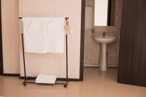 a bathroom with a towel rack and a sink at Picnic Park in Shenggeldi