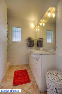 a white bathroom with a sink and a mirror at Villa CALANCA - Domaine La Raggia in Olmeto