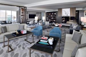 
a living room filled with furniture and a large window at Address Downtown in Dubai
