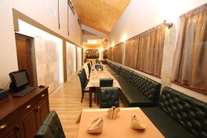 a row of tables and chairs in a restaurant at Complex Trakite in Elkhovo