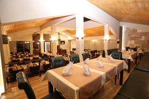 a restaurant with tables and chairs in a room at Complex Trakite in Elkhovo