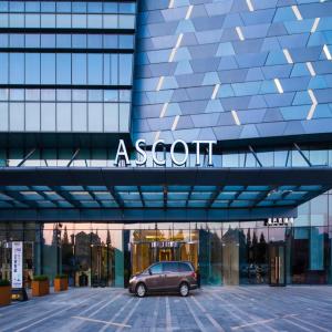a car parked in a parking lot in front of a building at Ascott Harmony City Nantong in Nantong