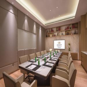 a conference room with a long table and chairs at Ascott Harmony City Nantong in Nantong