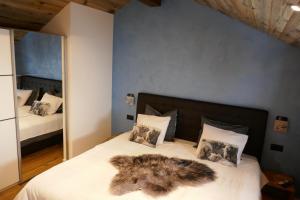 a bedroom with a bed with a furry blanket on it at Châlet Birkhahn in Saas-Fee
