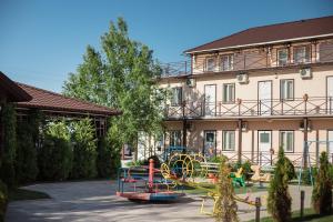 a building with a playground in front of a building at Picnic Park in Shenggeldi