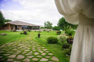 a garden with a stone path and a building at Soho Beach Hotel in Krasnogorsk