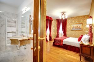 a hotel room with a bed and a dresser at Hotel Casanova in Venice