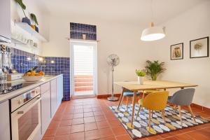 a kitchen with a table and chairs in a room at Spa Apartments Breza in Ljubljana