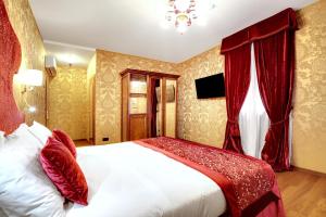 a hotel room with a large bed and a large window at Hotel Casanova in Venice