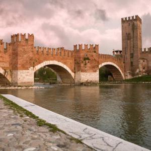 a large brick castle with a bridge over water at Buona Luce in Verona