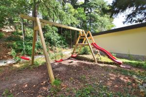 a wooden swing set with a ladder and a slide at Maestral Residence in Portorož