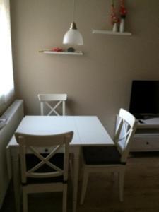a white table and two chairs in a room at Ferienwohnung Eckloff in Lutherstadt Wittenberg