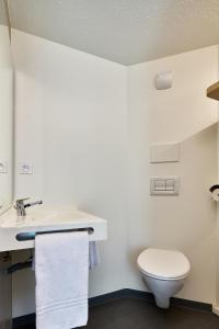a bathroom with a toilet and a sink at Première Classe La Roche Sur Yon - Vendéspace in Mouilleron-le-Captif