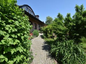 a brick path in front of a building with plants at Cozy Apartment in Buschenhagen with Sauna in Buschenhagen