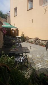 a patio with tables and chairs and a building at Pension Antica in Pilsen