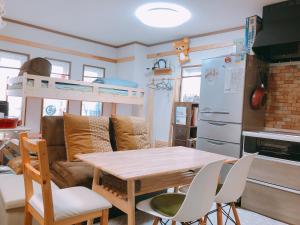 a kitchen and living room with a table and a couch at Ryokoheya Hankyukan in Osaka