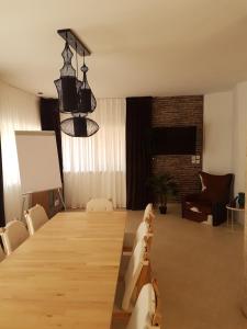 a conference room with a long wooden table and chairs at Desert Gat in Qiryat Gat
