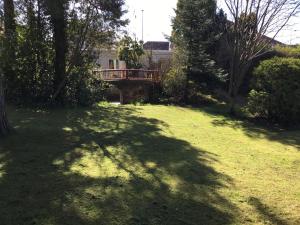 a bridge over a grassy yard with a house at Ingleneuk Bed and Breakfast in Edinburgh