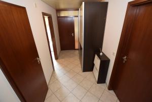 a hallway with two doors and a tile floor at AB Apartment Objekt 39 in Stuttgart +2 photos