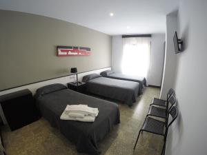 Posteľ alebo postele v izbe v ubytovaní Hostal Mediterráneo