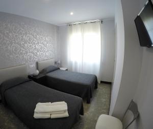 Posteľ alebo postele v izbe v ubytovaní Hostal Mediterráneo