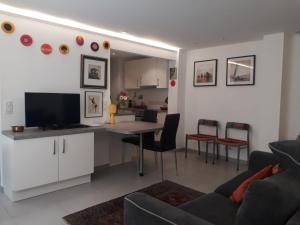 eine Küche und ein Wohnzimmer mit einem Tisch und Stühlen in der Unterkunft Le Tivoli in Cannes