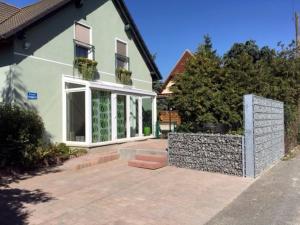a house with a patio in front of it at Ferienwohnung Schlossvorstadt in Lutherstadt Wittenberg