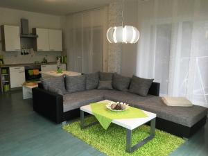 a living room with a couch and a table at Ferienwohnung Schlossvorstadt in Lutherstadt Wittenberg