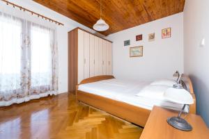 a bedroom with a bed and a table with two lamps at Apartments & Rooms Tapera in Dubrovnik