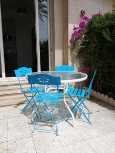 a table and two chairs and a table and chairs at Nice Promenade Apartment in Nice
