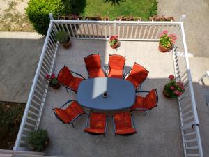 an overhead view of a table and red chairs at Guest House Regina Mundi in Međugorje +59 photos