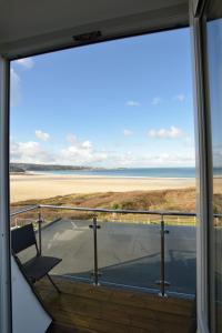 a view of the beach from the balcony of a house at The Penellen guest accommodation room only in Hayle