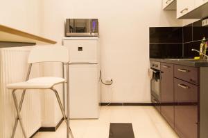 a kitchen with a white refrigerator and a microwave at Wonderful Apartment Budapest in Budapest