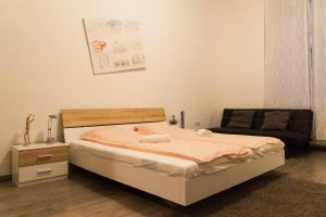 a bedroom with a bed and a couch at Wonderful Apartment Budapest in Budapest