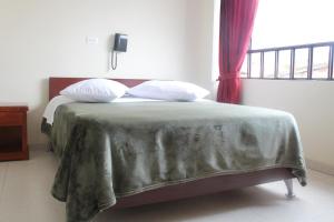 Postel nebo postele na pokoji v ubytování Hotel Vigua