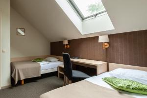 Postel nebo postele na pokoji v ubytování Hotel Sigulda