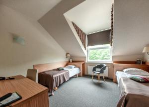 a room with two beds and a window at Hotel Sigulda in Sigulda +99 photos