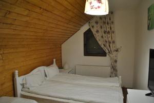 a bedroom with a white bed and a window at Casa Magnolia in Bran