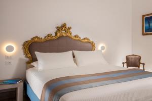 a bedroom with a large bed and a chair at GCF Luxury Suites, Guest house in Rome