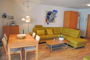 a living room with a couch and a table at Haus Strandburg in Binz