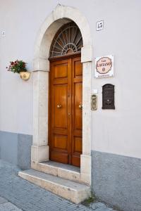 a wooden door of a building with a sign on it at B&B Casa Laviano in Melfi